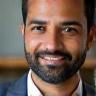 Ajay Patel, Director, smiling in Manchester office